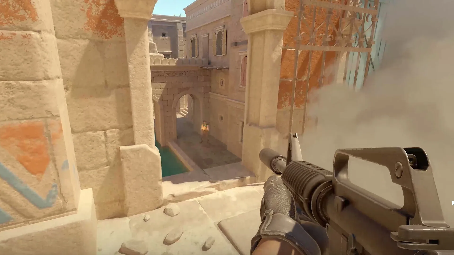 Official CS2 store screenshot showing smoke covering a narrow stone map sightline from a player view